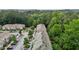 A captivating view of townhomes, showcasing ample parking and green landscaping in a serene, wooded setting at 220 Mount Evans Dr, Durham, NC 27705