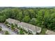 Beautiful aerial view of townhomes surrounded by mature trees and lush greenery and plenty of parking at 220 Mount Evans Dr, Durham, NC 27705