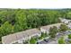 Wonderful aerial view of townhomes, featuring parking, well manicured landscaping and a lush green backdrop at 220 Mount Evans Dr, Durham, NC 27705