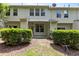 View of the building's exterior and backyard area, showcasing maintained shrubs and partial fencing at 220 Mount Evans Dr, Durham, NC 27705