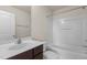 Bright bathroom featuring a tub and shower combination, a modern sink, and a vanity with a dark wood finish at 220 Mount Evans Dr, Durham, NC 27705