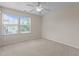 A neutrally painted bedroom features new carpet and ample natural light from the large windows at 220 Mount Evans Dr, Durham, NC 27705