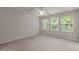Bright bedroom with plush carpet, ceiling fan and three windows offering natural light at 220 Mount Evans Dr, Durham, NC 27705
