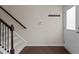 This home's entryway features a coat rack, thermostat, a staircase, and hardwood floors at 220 Mount Evans Dr, Durham, NC 27705