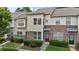 Townhome showcasing a blend of brick and siding exterior, complemented by a neatly landscaped front yard at 220 Mount Evans Dr, Durham, NC 27705