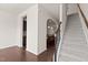 Inviting foyer with hardwood floors, staircase, and arched doorway leading to the kitchen at 220 Mount Evans Dr, Durham, NC 27705