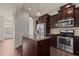 Modern kitchen with granite countertops, stainless steel appliances, and dark cabinets at 220 Mount Evans Dr, Durham, NC 27705