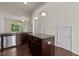 An open kitchen features stainless steel appliances, an island, a breakfast bar, and dark wood cabinets at 220 Mount Evans Dr, Durham, NC 27705
