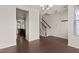 Open living area with hardwood floors, stairs, and view into the modern kitchen at 220 Mount Evans Dr, Durham, NC 27705