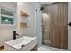 Bathroom featuring modern vanity with bowl sink, shelves, and glass-enclosed shower at 2200 Wyman Pl, Durham, NC 27707