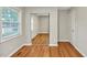 Cozy bedroom showcasing hardwood floors and a closet with sliding mirror doors at 2200 Wyman Pl, Durham, NC 27707
