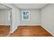 Bright bedroom with hardwood floors, fresh paint, and closet with mirrored doors at 2200 Wyman Pl, Durham, NC 27707
