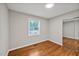 Bedroom with hardwood floors, a window, and closet with mirrored doors at 2200 Wyman Pl, Durham, NC 27707
