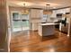 Modern kitchen with white cabinets, a center island, stainless steel appliances, and access to a deck at 2200 Wyman Pl, Durham, NC 27707