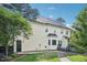 Back exterior showcasing bay window, brick pathway, and the yellow siding of the well-maintained home at 231 Heather Bluffs Dr, Garner, NC 27529