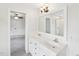 Bathroom featuring a double vanity sink, an open doorway, and good lighting at 231 Heather Bluffs Dr, Garner, NC 27529