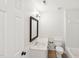 Clean white bathroom with dark wood framed mirror, marble countertop, and white porcelain sink at 231 Heather Bluffs Dr, Garner, NC 27529