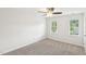 Bedroom with natural light, soft gray carpet, and neutral paint at 231 Heather Bluffs Dr, Garner, NC 27529
