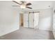Bedroom featuring gray carpet, a ceiling fan, barn door to the bathroom, and white walls at 231 Heather Bluffs Dr, Garner, NC 27529