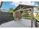 Wooden deck with a shaded seating area, black metal railings, and privacy screen at 231 Heather Bluffs Dr, Garner, NC 27529