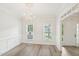 Bright dining room features decorative chandelier, wainscoting and wood-look floors at 231 Heather Bluffs Dr, Garner, NC 27529