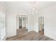 Open dining room features modern chandelier, wood-look floors and an open floorplan at 231 Heather Bluffs Dr, Garner, NC 27529