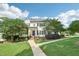Charming two-story home featuring a well-manicured lawn, mature trees, and inviting walkway at 231 Heather Bluffs Dr, Garner, NC 27529