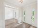 Bright foyer featuring hardwood floors, a modern chandelier, and an open view into the dining room at 231 Heather Bluffs Dr, Garner, NC 27529