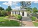 Exterior shot of guest house with brick walkway, shutters, landscaping, and gray staircase at 231 Heather Bluffs Dr, Garner, NC 27529