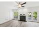 Bright living room with a fireplace, hardwood floors, and access to the outdoor deck at 231 Heather Bluffs Dr, Garner, NC 27529