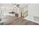 Bright living room featuring hardwood floors, an open concept, and a view of the kitchen at 231 Heather Bluffs Dr, Garner, NC 27529