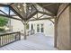 View of the covered patio with stylish chandelier and access to the house with neutral tones at 231 Heather Bluffs Dr, Garner, NC 27529