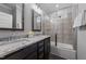 Bathroom features a dual vanity, granite counters, updated fixtures, and a shower over tub at 2500 Plowridge Rd, Fuquay Varina, NC 27526