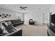 Upstairs bonus room featuring a black leather sectional and a ceiling fan at 2500 Plowridge Rd, Fuquay Varina, NC 27526