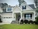 Attractive home with a cozy front porch, white railings, and well-maintained landscaping at 2500 Plowridge Rd, Fuquay Varina, NC 27526