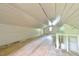 Spacious attic featuring wooden floors, beadboard paneling, and a window at the far end at 2602 Francis St, Durham, NC 27707