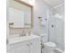 Cozy bathroom features a glass enclosed shower, a white sink and vanity with a framed mirror at 2602 Francis St, Durham, NC 27707