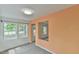 Well-lit living room with neutral colors, neutral carpet, with views of trees from the windows at 2602 Francis St, Durham, NC 27707
