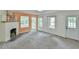 Spacious living room featuring neutral carpet, updated windows, and views into another room at 2602 Francis St, Durham, NC 27707
