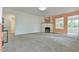 Bright living room with modern fireplace, neutral carpet and an open layout with an adjacent room at 2602 Francis St, Durham, NC 27707