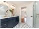 Stylish bathroom features dual sinks, decorative tile flooring and glass-door shower at 2714 Wedgedale Ave, Durham, NC 27703
