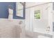 Bright bathroom with white subway tile, modern fixtures, and a tub-shower combo at 2714 Wedgedale Ave, Durham, NC 27703
