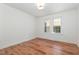 Cozy bedroom with two windows offering natural light and wood-look flooring at 2714 Wedgedale Ave, Durham, NC 27703