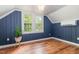 Charming bedroom with paneled walls, wood-look flooring, and plenty of light at 2714 Wedgedale Ave, Durham, NC 27703