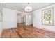 Open dining room with hardwood floors and natural light from large window at 2714 Wedgedale Ave, Durham, NC 27703