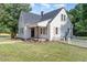 Charming white two-story home featuring a brick chimney, black shutters, and a manicured lawn at 2714 Wedgedale Ave, Durham, NC 27703