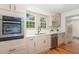 Bright kitchen featuring stainless steel appliances, light cabinets, and a window view at 2714 Wedgedale Ave, Durham, NC 27703