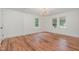 Bright living room with wood floors and natural light from the double window at 2714 Wedgedale Ave, Durham, NC 27703
