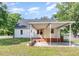 This home features a rear carport and access, a brick foundation, and a yard with mature trees at 2714 Wedgedale Ave, Durham, NC 27703