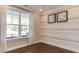 Bright bedroom with decorative wall, hardwood floors, large window and elegant crown molding at 2964 Hanging Valley Way, Wake Forest, NC 27587
